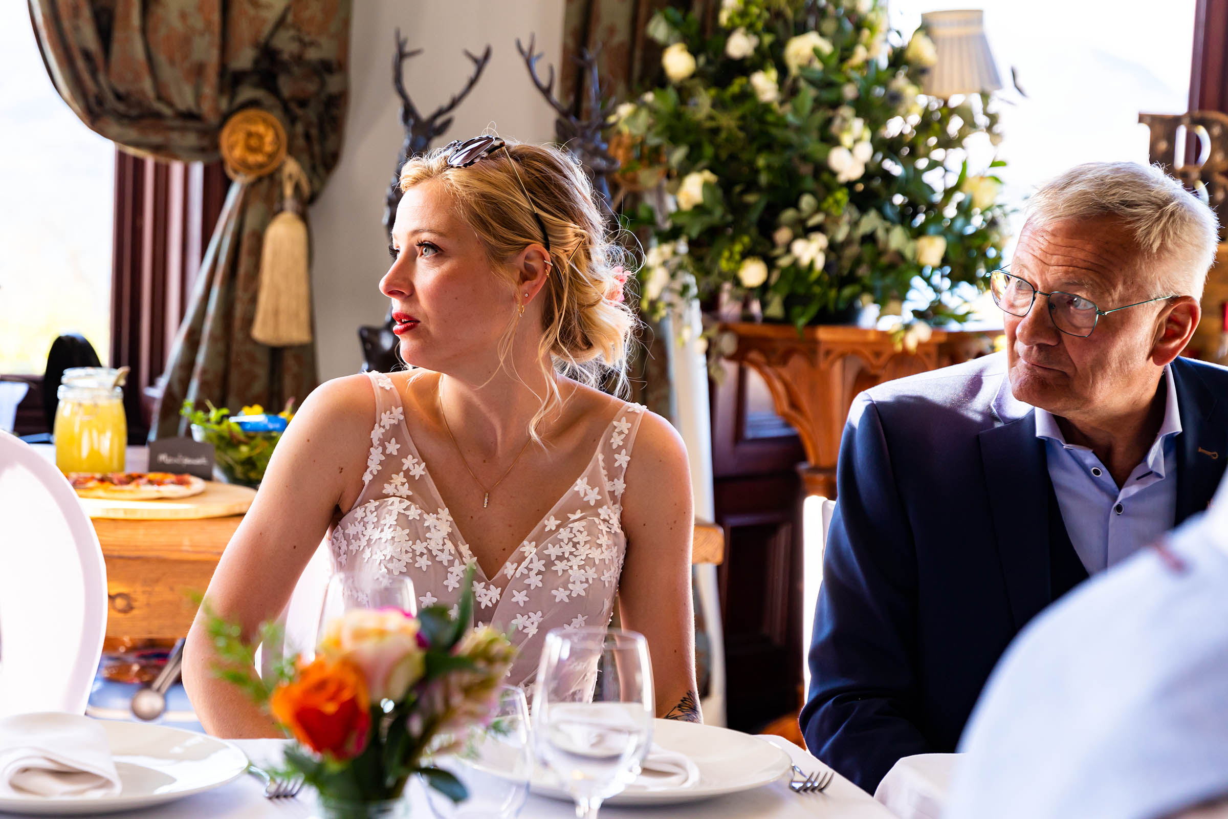 bride sitting at table with wine bottle