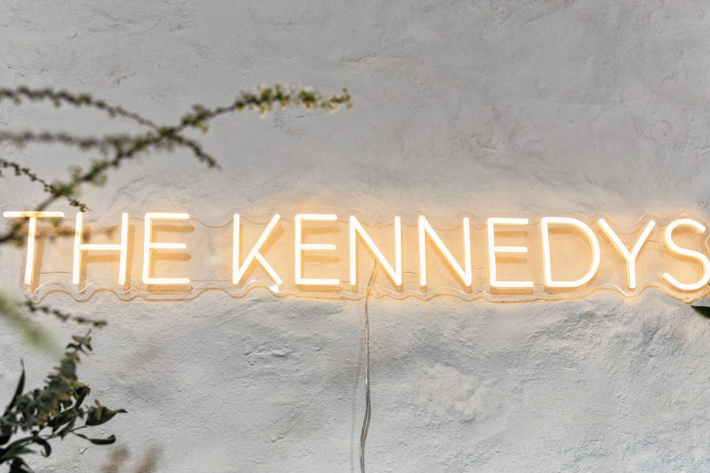 neon wedding sign saying the Kennedys